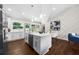 Open concept kitchen with an island, white countertops, stainless steel appliances, and modern lighting at 3388 Elgin Dr, Decatur, GA 30032