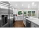 Modern kitchen featuring stainless steel appliances, white cabinets, and a large island with seating at 3388 Elgin Dr, Decatur, GA 30032