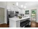 Modern eat-in kitchen with stainless appliances, white cabinets, large island, and backyard access at 3388 Elgin Dr, Decatur, GA 30032