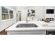 Modern kitchen island with stainless steel sink, white countertops, and stylish decor at 3388 Elgin Dr, Decatur, GA 30032
