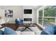 Cozy living room featuring a modern fireplace, large window with view, and stylish decor at 3388 Elgin Dr, Decatur, GA 30032