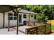 The patio includes a pergola, modern railings, and a blue door leading into the white brick house at 3388 Elgin Dr, Decatur, GA 30032