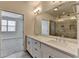 Bathroom featuring double vanity, large mirror, walk-in shower with gray tiles and a view to the bedroom at 3879 Glenview Club Ln, Duluth, GA 30097