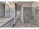 Bathroom featuring double vanity, large mirror, walk-in shower with gray tiles, and tile flooring at 3879 Glenview Club Ln, Duluth, GA 30097