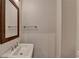 Neutral powder room featuring a pedestal sink, framed mirror and brushed nickel hardware at 3879 Glenview Club Ln, Duluth, GA 30097