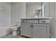 Bathroom featuring white subway tiles in shower and gray vanity with drawers and cabinets at 3879 Glenview Club Ln, Duluth, GA 30097