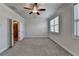 Bedroom featuring neutral carpet, ceiling fan, and windows with horizontal blinds at 3879 Glenview Club Ln, Duluth, GA 30097