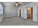 Large bedroom with carpeting, ceiling fan, and open doors to bath and closet at 3879 Glenview Club Ln, Duluth, GA 30097