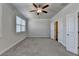 Bedroom featuring neutral carpet, ceiling fan, and doors to closet and bathroom at 3879 Glenview Club Ln, Duluth, GA 30097