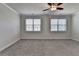 Bedroom featuring neutral carpet, ceiling fan, and windows with horizontal blinds at 3879 Glenview Club Ln, Duluth, GA 30097