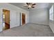 Spacious bedroom with ceiling fan, carpet, and doorways to closet and bath at 3879 Glenview Club Ln, Duluth, GA 30097