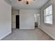 Bright bedroom with plush carpet, ceiling fan, closet and ensuite bathroom access at 3879 Glenview Club Ln, Duluth, GA 30097