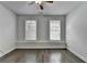 Bedroom with hardwood floors, ceiling fan, and two large windows offering ample lighting at 3879 Glenview Club Ln, Duluth, GA 30097