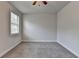 Bedroom with neutral walls, carpet, one window overlooking the neighborhood, and ceiling fan at 3879 Glenview Club Ln, Duluth, GA 30097