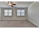 Bedroom featuring neutral carpet, ceiling fan, and windows with horizontal blinds at 3879 Glenview Club Ln, Duluth, GA 30097
