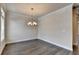 Elegant dining room with hardwood floors, chandelier, and bright natural light at 3879 Glenview Club Ln, Duluth, GA 30097
