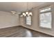 Stylish dining area with hardwood floors, modern lighting, and multiple windows at 3879 Glenview Club Ln, Duluth, GA 30097