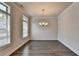 Well-lit dining room featuring hardwood floors, a chandelier, and bright windows at 3879 Glenview Club Ln, Duluth, GA 30097