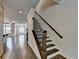 Inviting hallway with hardwood floors, staircase, and view to living area at 3879 Glenview Club Ln, Duluth, GA 30097