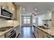 Bright kitchen with granite countertops, stainless steel appliances, and open view to living room at 3879 Glenview Club Ln, Duluth, GA 30097