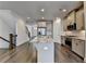 Modern kitchen featuring stainless appliances, granite counters, hardwood floors, and an island sink at 3879 Glenview Club Ln, Duluth, GA 30097