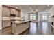 Open concept kitchen with granite island, stainless appliances, recessed lighting, and hardwood floors at 3879 Glenview Club Ln, Duluth, GA 30097