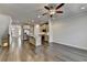 Bright, open living room with hardwood floors, ceiling fan, and view of the kitchen area at 3879 Glenview Club Ln, Duluth, GA 30097