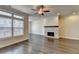 Bright living room with large window, fireplace, ceiling fan, and hardwood floors at 3879 Glenview Club Ln, Duluth, GA 30097