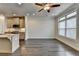 Open-concept living area featuring hardwood floors, modern lighting, and large windows for natural light at 3879 Glenview Club Ln, Duluth, GA 30097
