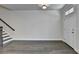 Open living space featuring hardwood floors, stairs, and entry door at 3879 Glenview Club Ln, Duluth, GA 30097