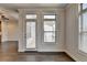 Bright room with dark hardwood floors and a glass patio door letting in natural light at 3879 Glenview Club Ln, Duluth, GA 30097