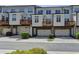 View of townhomes featuring garage parking and small wooden decks at 3879 Glenview Club Ln, Duluth, GA 30097