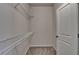 Walk-in closet with metal shelving, neutral walls, carpeted floor, and white door at 3879 Glenview Club Ln, Duluth, GA 30097