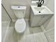 Bathroom with new tile flooring and a toilet and grey vanity at 559 Allgood Rd, Stone Mountain, GA 30083