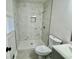 Bathroom featuring a new marble-look walk-in shower and modern fixtures at 559 Allgood Rd, Stone Mountain, GA 30083