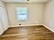 Bedroom with wood-look flooring and a window letting in natural light at 559 Allgood Rd, Stone Mountain, GA 30083