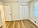 Bedroom features wood-look floors and a closet with double doors at 559 Allgood Rd, Stone Mountain, GA 30083