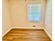 Bedroom with hardwood floors, a large window, and bright trim at 559 Allgood Rd, Stone Mountain, GA 30083