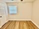 Bedroom with wood-look flooring and a window letting in natural light at 559 Allgood Rd, Stone Mountain, GA 30083