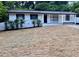 Charming single-story home featuring a white brick facade and updated landscaping at 559 Allgood Rd, Stone Mountain, GA 30083