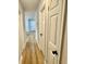 Hallway with wood-look flooring and white doors with black hardware at 559 Allgood Rd, Stone Mountain, GA 30083