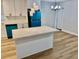 Modern kitchen featuring a large island, stainless appliances, and contemporary lighting fixtures at 559 Allgood Rd, Stone Mountain, GA 30083