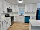 Well-lit kitchen with white cabinets, stainless steel appliances, and modern countertops at 559 Allgood Rd, Stone Mountain, GA 30083