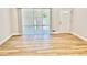 Living room with luxury vinyl plank flooring, sliding glass door, and neutral paint at 559 Allgood Rd, Stone Mountain, GA 30083