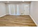 Bright living room featuring hardwood floors, and a large window with natural light at 559 Allgood Rd, Stone Mountain, GA 30083