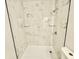 Shower featuring marble-look tile and glass shelving at 559 Allgood Rd, Stone Mountain, GA 30083