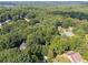 Aerial view of a home nestled within a heavily treed and private neighborhood at 6520 Fairfield Trce, Suwanee, GA 30024