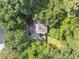 Aerial view of a house surrounded by lush green trees in a quiet neighborhood at 6520 Fairfield Trce, Suwanee, GA 30024