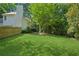 Green lawn with mature trees in the backyard of a charming home at 6520 Fairfield Trce, Suwanee, GA 30024