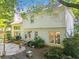 Stone backyard patio featuring outdoor lighting, landscaping and a gas grill at 6520 Fairfield Trce, Suwanee, GA 30024